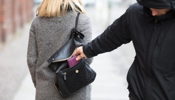 Close-up Of A Person Stealing Purse From Handbag