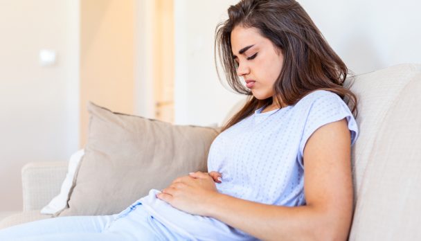Woman,Lying,On,Sofa,Looking,Sick,In,The,Living,Room.