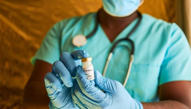 An,African,Doctor,Holding,A,Covid,19,Vaccine,Vial,In